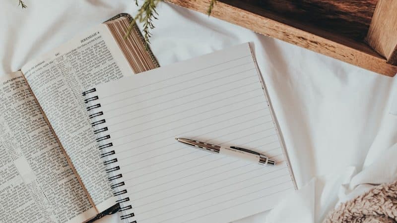 white notebook on white textile