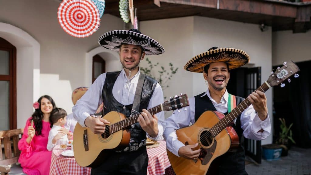 Men Singing and Playing Guitar in a Party